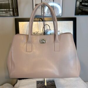 NWOT Furla tan handbag comes with dust. Bag has silver tone twist lock closure.